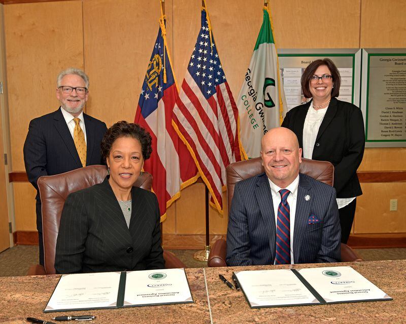 Georgia Gwinnett College President Jann Joseph (seated, left) and Gwinnett Tech President D. Glen Cannon (seated, right) pose after signing an articulation agreement for students seeking to transfer credits from the technical school to GGC. 