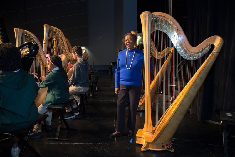 Roselyn Lewis, executive director of the Urban Youth Harp Ensemble, poses for a photograph during a recent practice at the Drew Charter School. Lewis helped found the ensemble in 2000. STEVE SCHAEFER / SPECIAL TO THE AJC