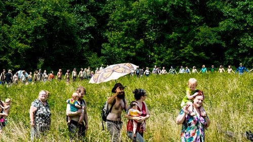 People gather in a meadow at the Rainbow Family of Living Light Gathering which took place for the first time in Georgia at Chattahoochee-Oconee National Forest. The event began as early as June 12, with the high point from July 1 through July 7, 2018. (Cynthia Herms/CynthiaHerms.com)