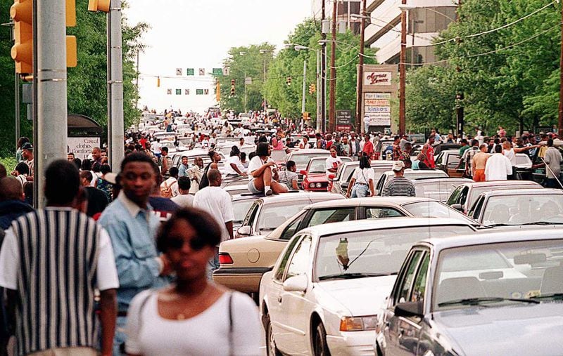 Freaknik revelers bring Lenox Road traffic to a standstill after Lenox Square and Phipps Plaza malls closed early on a Saturday in 1995. (John Spink/The Atlanta Journal-Constitution/TNS)
