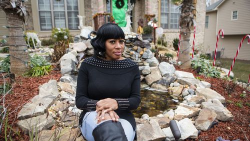 Valerie Ghant poses for a photo in front of her house in south Fulton County. Ghant is facing a $25,000 lien from her homeowner association for building a therapeutic garden on her front lawn for her daughter who suffered a traumatic brain injury. CHRISTINA MATACOTTA FOR THE ATLANTA JOURNAL-CONSTITUTION.