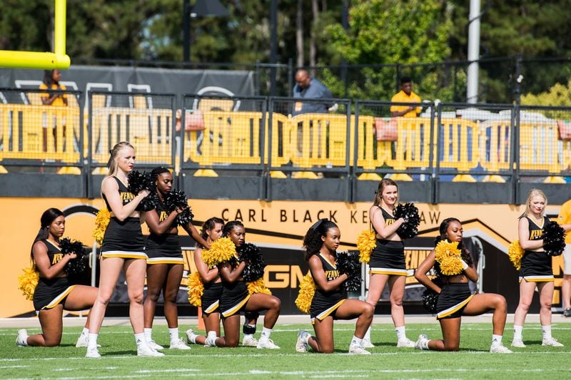 A handful of cheerleaders take a knee during the national anthem prior to the matchup between Kennesaw State and North Greenville, Saturday, Sept. 30, 2017. (Special to AJC/by Cory Hancock)