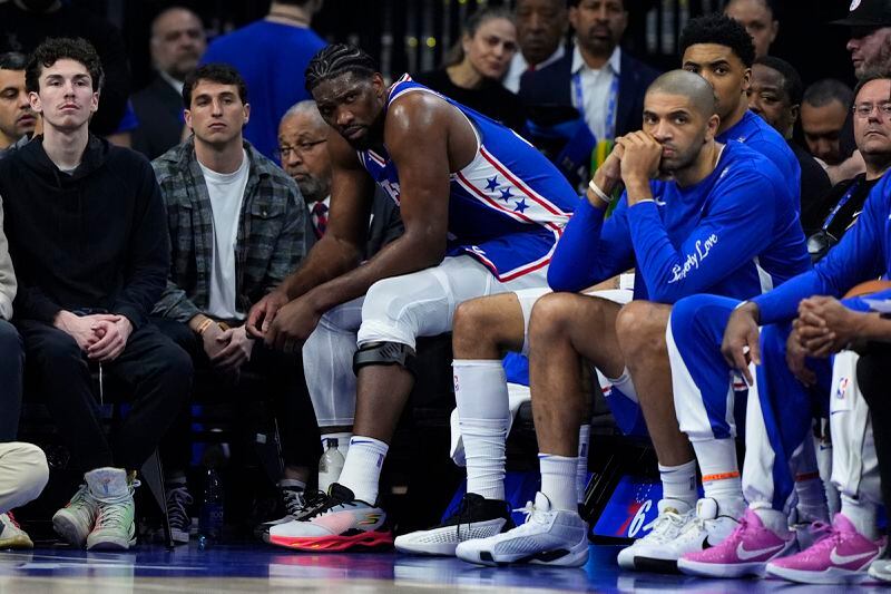 Philadelphia 76ers' Joel Embiid watches from the bench during the first half of an NBA basketball game against the Oklahoma City Thunder, Tuesday, April 2, 2024, in Philadelphia. (AP Photo/Matt Slocum)