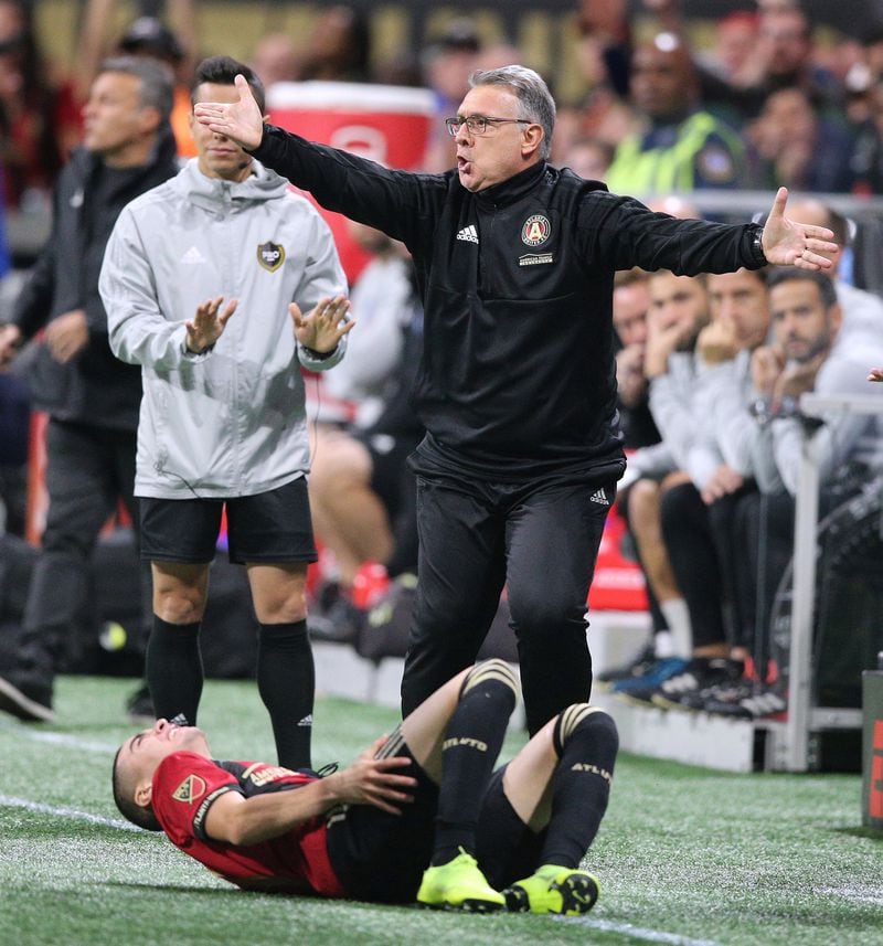 Gerardo Martino pleads his case for one of his downed men, Miguel Almiron. (Curtis Compton/Atlanta Journal-Constitution/TNS)