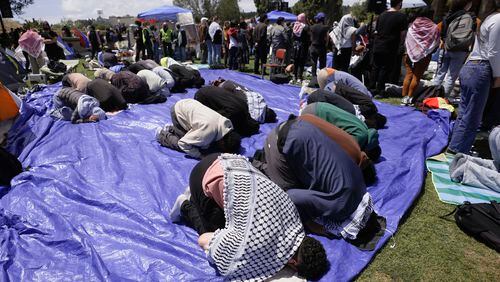 Protesters pray at an encampment staged to support the Palestinian cause on the UCLA campus Thursday, April 25, 2024, in Los Angeles. (AP Photo/Jae C. Hong)