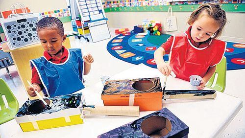 Jason Morton (left) and Layne Sherman, then 4-years-old, make guitars out of shoeboxes and empty paper towel rolls at the Primrose School of Midtown in 2010. The owner opened the center that year after trying unsuccessfully to find intown day care.