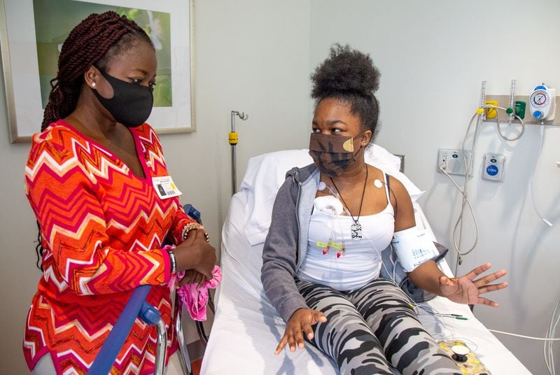  Mapillar Dahn talks with her daughter Khadeejah Tyler, 15, while she undergoes her sickle cell anemia treatment at the Scottish Rite Children's Hospital in Atlanta October 7, 2020 (Steve Schaefer for The Atlanta Journal-Constitution)  