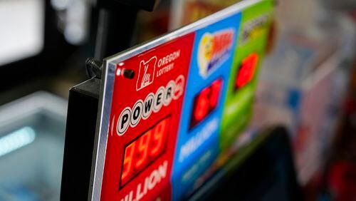 A sign for the Powerball jackpot is displayed at a 7-Eleven, Friday, April 5, 2024, in Portland, Ore. (AP Photo/Jenny Kane)