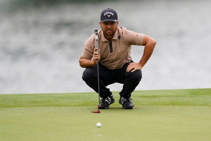 Xander Schauffele lines up a putt on the 14th hole during the first round of the Wells Fargo Championship golf tournament at the Quail Hollow Club Thursday, May 9, 2024, in Charlotte, N.C. (AP Photo/Erik Verduzco)