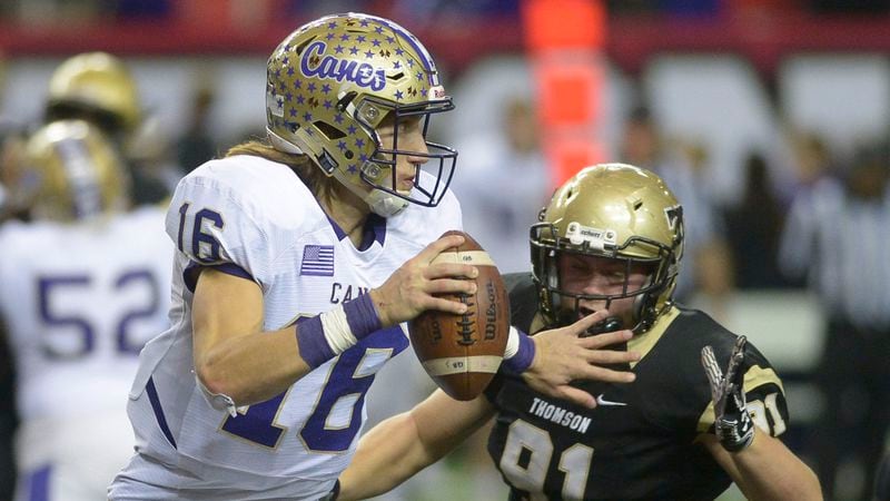Thomson defensive Will Roberts (91) puts pressure on Cartersville quarterback Trevor Lawrence (16) during a play in the second half of the Class 4A state title game Saturday, Dec. 10, 2016, at the Georgia Dome in Atlanta. (Daniel Varnado/For the AJC)