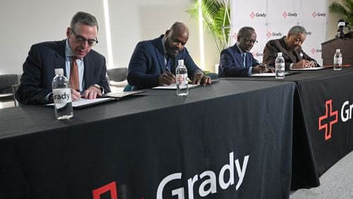 Officials from Grady, Fulton and DeKalb counties (from left) John Haupert, president and CEO of Grady Health System, Jevon Gibson, CEO of The Fulton-DeKalb Hospital Authority, Mike Thurmond, CEO of DeKalb County, and Robb Pitts, Chairman of the Fulton County Board of Commissioners, sign documents during a press conference to announce and sign a new deal to subsidize the hospital for indigent medical care at Grady Memorial Hospital, Tuesday, December 9, 2024, in Atlanta. (Hyosub Shin / Hyosub.Shin@ajc.com)