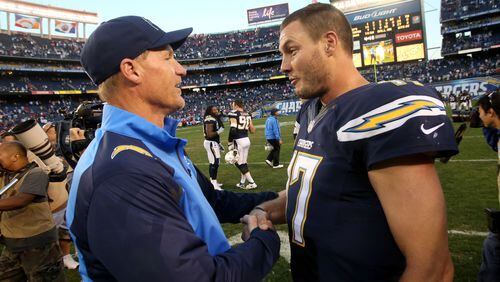Quarterback Philip Rivers and offensive coordinator Ken Whisenhunt of the San Diego Chargers celebrate after the game with the Kansas City Chiefs at Qualcomm Stadium on December 29, 2013 in San Diego, California. The Chargers won 27-2 in overtime. (Photo by Stephen Dunn/Getty Images)