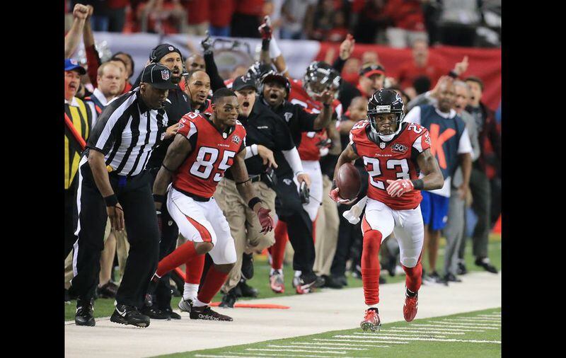 SUDDEN DEATH: The Falcons sideline reacts as Robert Alford intercepts Redskins quarterback Kirk Cousins in overtime and returns it for the game-winning touchdown and a final score of 25-19 in their football game on Sunday, Oct. 11, 2015, in Atlanta. The Falcons remain perfect at 5-0 with the victory. Curtis Compton