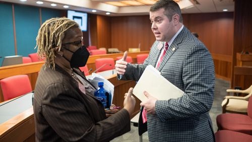 Rep. Doreen Carter, D-Lithonia, who opposes House Bill 1084, talks with the bill’s sponsor Rep. Will Wade, R-Dawsonville, after a House Education subcommittee hearing on the bill Wednesday, Feb. 9, 2022. (Ben Gray for The Atlanta Journal-Constitution)