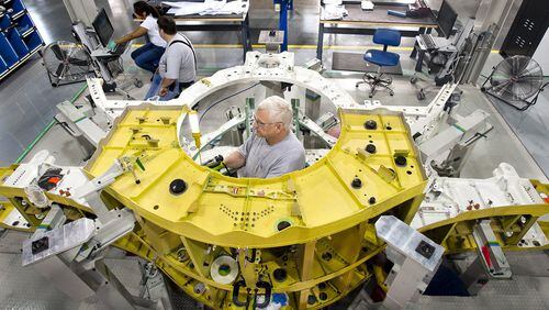 Lockheed Martin mechanics assemble components of an F-35 Joint Strike Fighter’s center wing in Marietta. A defense policy bill that the U.S. House approved Friday calls for adding 87 more of the planes to the military’s fleet. (Photo by John Rossino, Lockheed Martin Aeronautics Co.)