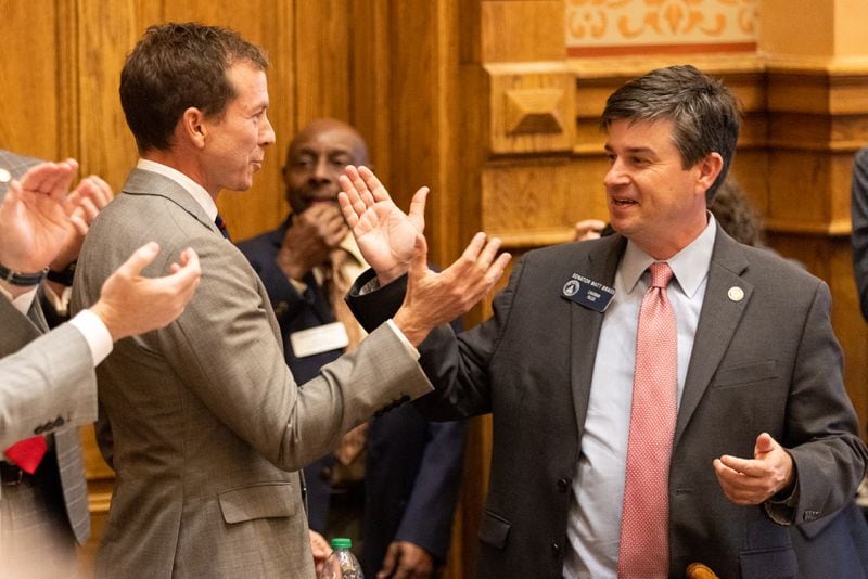 Left to right: Sen. Greg Dolezal, R-Cumming, is congratulated by Sen. Matt Brass, R-Newnan, following the passage of a school voucher bill.