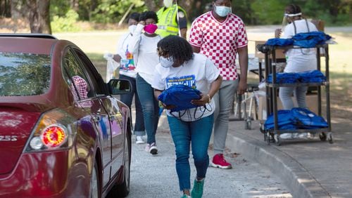 Volunteers hand out free backpacks and other schools supplies at Kemp Elementary Saturday morning in Hampton, Georgia, on August 8, 2020. STEVE SCHAEFER FOR THE ATLANTA JOURNAL-CONSTITUTION
