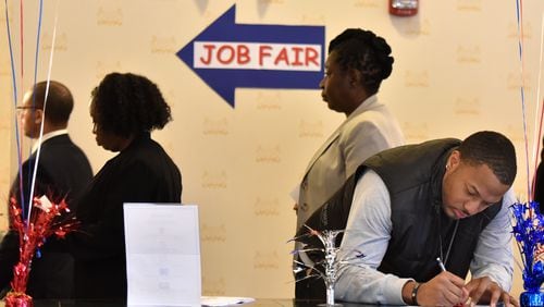 In this file photo, potential hires search for jobs. HYOSUB SHIN / HSHIN@AJC.COM