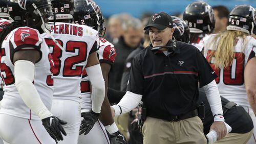 Atlanta Falcons head coach Dan Quinn greets his players on the sidelines in the second half of an NFL football game against the Carolina Panthers in Charlotte, N.C., Saturday, Dec. 24, 2016. The Falcons won 33-16. (AP Photo/Bob Leverone)