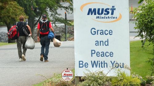 A pair of homeless men head out for the day after getting some assistance at MUST Ministries on Wednesday, August 9, 2017, in Cobb County.   Curtis Compton/ccompton@ajc.com