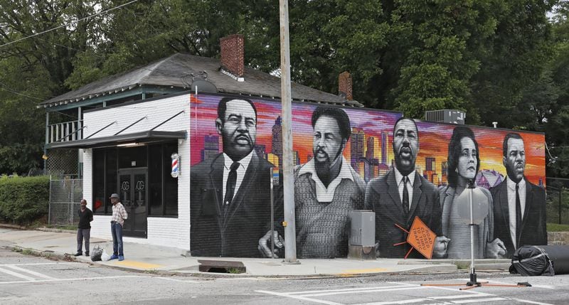 Samuel Glickman, owner of Provado Grooming, donated the wall of his building for a civil rights leaders mural in the historic African American neighborhood of Vine City. Bob Andres / bandres@ajc.com