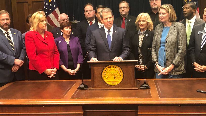 Gov. Brian Kemp unveiled a plan Thursday that would invest more than $300 million in public money into reinsurance — money that would be paid to insurance companies and meant to trickle down and lower premium prices. The plan would also require the state to build its own online system that would guide residents to private web brokers who could sell them insurance.