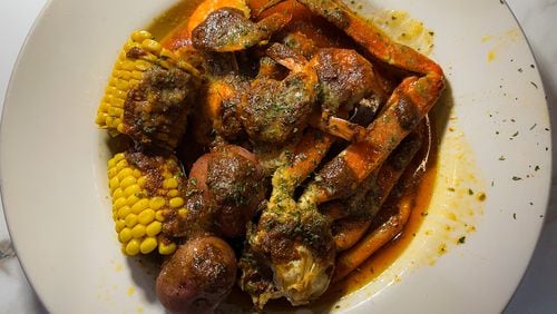 Combo No. 1 at the Seafood Menu includes a snow crab cluster, six steamed shrimp, corn and potatoes. Henri Hollis/henri.hollis@ajc.com