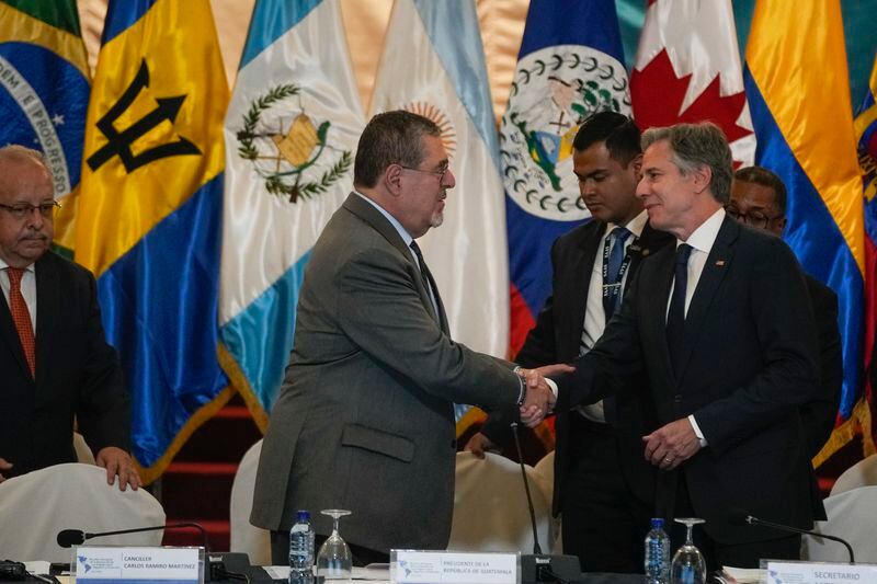 Guatemalan President Bernardo Arevalo, center, shakes hands with U.S. Secretary of State Antony Blinken at the National Palace in Guatemala City, Tuesday, May 7, 2024. Blinken is in Guatemala for a two-day visit where he will attend a regional meeting on irregular migration. (AP Photo/Moises Castillo)