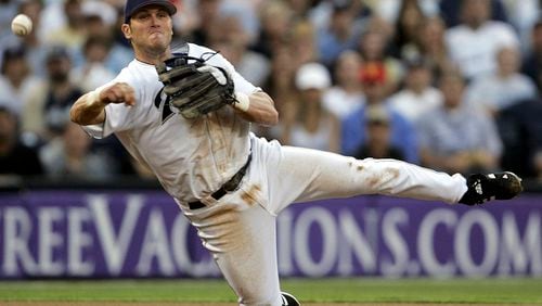 San Diego Padres third baseman Sean Burroughs fires a throw to first from his knees but is unable to get Los Angeles Dodgers' D. J. Houlton at first during the third inning of a baseball game June 22, 2005, in San Diego.  (AP Photo/Lenny Ignelzi, File)