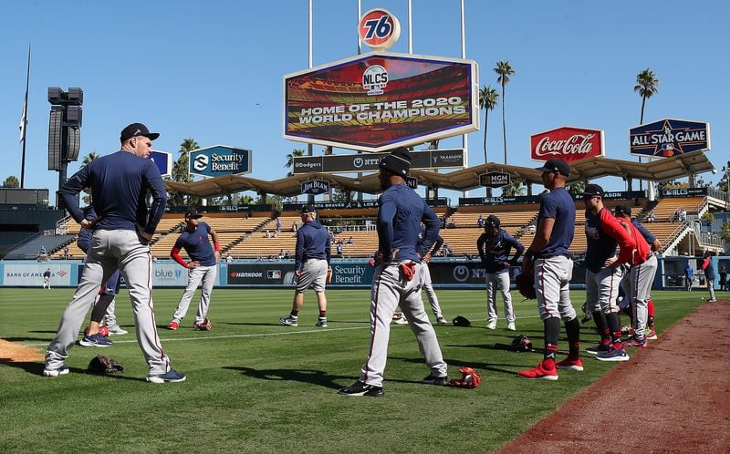 Braves first baseman Freddie Freeman (left) and teammates loosen up in Dodger Stadium while preparing for Game 3 of the NLCS against the Los Angeles Dodgers Tuesday, Oct. 19, 2021, in Los Angeles. (Curtis Compton / Curtis.Compton@ajc.com)