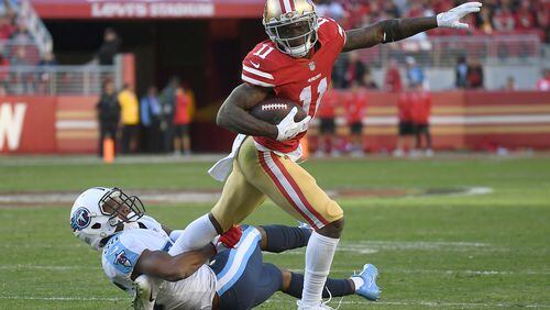 SANTA CLARA, CA - DECEMBER 17:  Marquise Goodwin #11 of the San Francisco 49ers tries to fight off the tackle of LeShaun Sims #36 of the Tennessee Titans late in the fourth quarter of their NFL football game at Levi's Stadium on December 17, 2017 in Santa Clara, California.  (Photo by Thearon W. Henderson/Getty Images)
