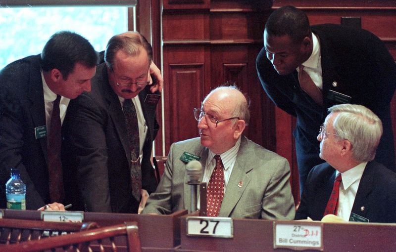 Speaker of the House Thomas Murphy, center, D-Bremen, holds court on the floor of the state House with, from left, Reps. Scott Tolbert, R-Pendergrass, Jack West, D-Bowdon, Arnold Ragas, D-Stone Mountain, and Bill Cummings, D-Rockmart, Wednesday, March 3, 1999 in Atlanta. (AP Photo/Alan Mothner)