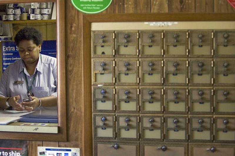 Postmaster Joyce Macfoy readies to close her office promptly at 3:30p each weekday.