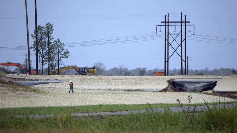 Gray water containing coal ask flows from a ruptured landfill at the L.V. Sutton Power Station in Wilmington, N.C., and flows toward Sutton Lake, near the Cape Fear River. (Kemp Burdette/Cape Fear River Watch via AP)