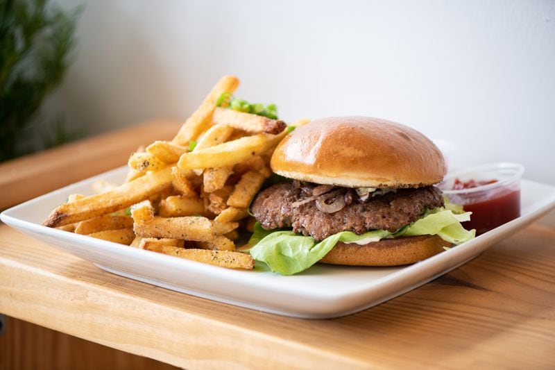 A hit from the Che Butter Jonez food truck that will show up at the restaurant is a lamb burger with lettuce, tomato, caramelized onions and jalapenos with an herb sauce and fries. Mia Yakel for The AJC