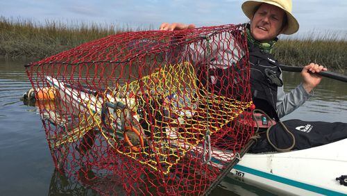 Coastal Expeditions’ Chris Crolley pulls up a crab trap during a kayak tour out of Shem Creek. Lori Rackl/Chicago Tribune/TNS