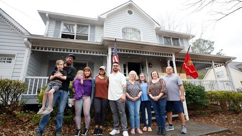 Antuan and Lexi Aguirre (center) have received generous support from neighbors in their Knotts Landing community near Woodstock since a fire burned much of their home. “It is phenomenal. It is jaw dropping,” Antuan Aguirre said of his neighbors’ efforts. “We will never, ever leave this neighborhood because of this.”
