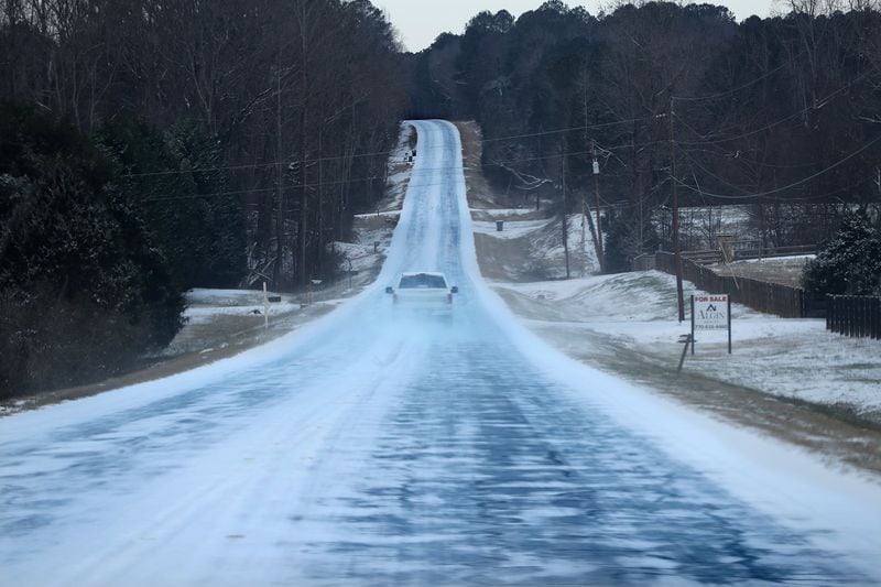 A solitary pickup truck braves the icy conditions driving down the middle of Georgia 142 in Newton County on Wednesday, Jan. 17, 2018, near Newborn. Curtis Compton/ccompton@ajc.com