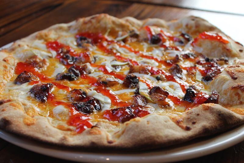 The Pork & Apple pizza from Fire Stone Wood Fired Pizza & Grill is finished off with a drizzle of pepper jelly for a little extra zing. Credit: Nicole Taylor