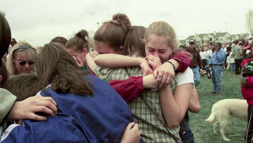Students the day after the mass shooting at Columbine High School in Littleton, Colo., April 21, 1999. That year, the Columbine High School massacre felt like an earthquake, but as of 2017, it is no longer one of the 10 deadliest mass shootings in postwar America. (Monica Almedia/The New York Times)