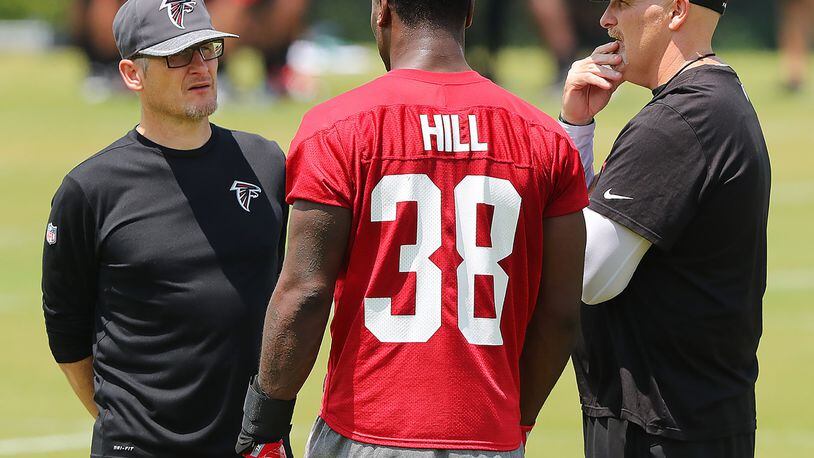 May 12, 2017, Flowery Branch: Falcons head coach Dan Quinn and General Manager Thomas Dimitroff talk with rookie running back Brian Hill, Wyoming, during rookie mini-camp on Friday, May 12, 2017, in Flowery Branch. Curtis Compton/ccompton@ajc.com