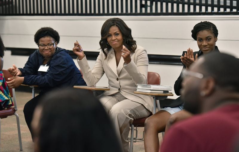 Former first lady Michelle Obama snaps her fingers approvingly as she meets with students from Spelman College and Morehouse College on Saturday, May 11, 2019. The students spent this past semester studying her memoir “Becoming” as a foundational text of their political science class “Black Women: Developing Public Leadership Skills.” HYOSUB SHIN / HSHIN@AJC.COM