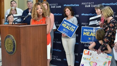 August 23, 2019 Atlanta - U.S. Representative Lucy McBath speaks as Vivienne Sacks (right), 5, holds a sign during “Protect Our Care Georgia Health Care Emergency” Press Conference at the Georgia State Capitol on Friday, August 23, 2019. Protect Our Care “Health Care Emergency” Bus Tour Continues With Stops in Maine, New Hampshire, North Carolina and Georgia. (Hyosub Shin / Hyosub.Shin@ajc.com)