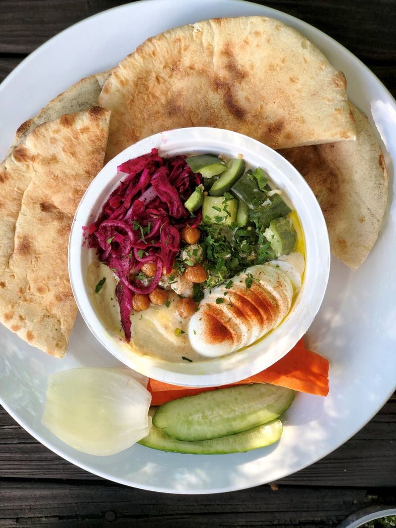 The hummus plate No. 1 at Rina comes with crispy chickpeas, pickled veggies, slaw, a hard boiled egg, plus pita and raw veggies for dipping. CONTRIBUTED BY WENDELL BROCK