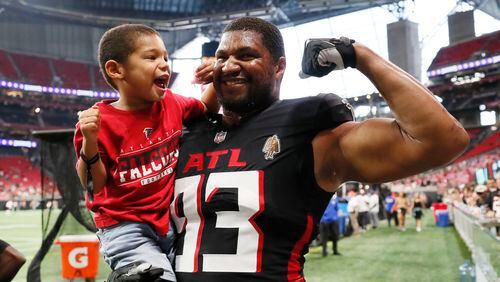 Falcons defensive tackle Calais Campbell (93) is seen playing with his son Dakari Campbell (3) moments before the preseason game against the Cincinnati Bengals at Mercedes-Benz Stadium on Friday, August 18, 2023, in Atlanta.Miguel Martinezmiguel.martinezjimenez@ajc.com