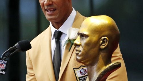 Former NFL player Jason Taylor speaks behind a bust of himself during an induction ceremony at the Pro Football Hall of Fame Satruday, August 5, 2017 in Canton, Ohio. (AP Photo/Gene J. Puskar)