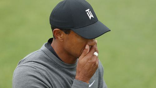 Tiger Woods stifles his disappointment while walking the 15th fairway at Shinnecock Hills Friday. (Streeter Lecka/Getty Images)