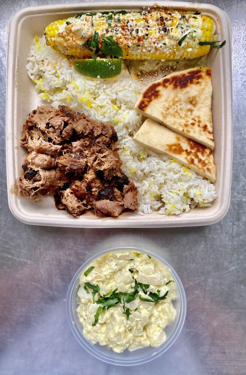 Local Expedition’s pulled pork plate is seen here with sides of Mexican corn and potato salad. Rice and pita come with the meal. Wendell Brock for The Atlanta Journal-Constitution