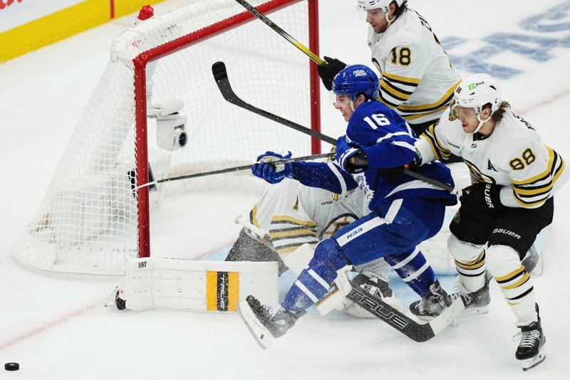 Toronto Maple Leafs' Mitch Marner (16) is stopped by Boston Bruins goaltender Jeremy Swayman (1) as Bruins' David Pastrnak (88) and Pavel Zacha (18) defend during the first period in Game 4 of an NHL hockey Stanley Cup first-round playoff series in Toronto on Saturday, April 27, 2024. (Nathan Denette/The Canadian Press via AP)