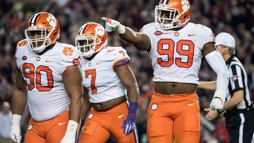 Clemson defensive end Clelin Ferrell (99), Dexter Lawrence (90) and Austin Bryant celebrate after a sack against South Carolina.